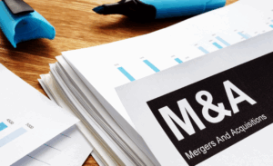 Documents about mergers and acquisitions m&a with a pen.