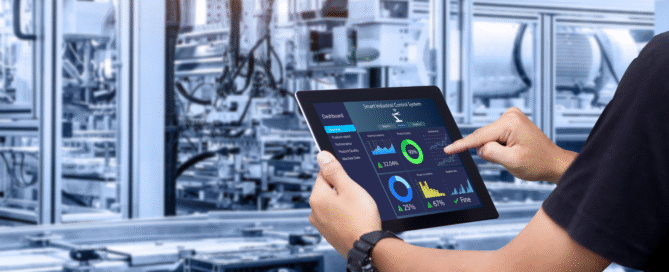 Hands pointing at a tablet that controls machinery